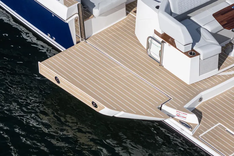 Slide: The Image of 2026 Tiara Yachts 43LE swim platform and seating area on water. - 28