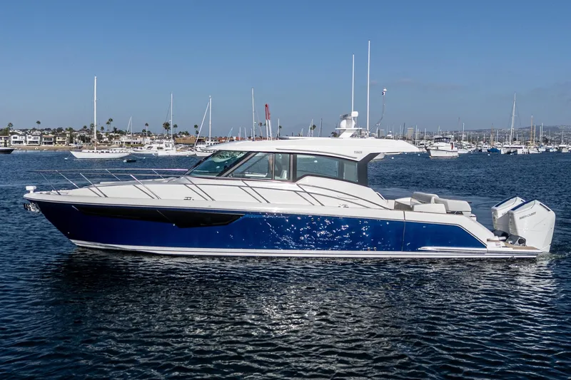 Slide: The Image of 2026 Tiara Yachts 43LE in blue and white, cruising on a sunny day. - 3