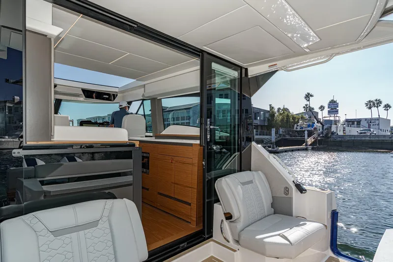 Slide: The Image of 2026 Tiara Yachts 43LE interior with waterfront view, showcasing luxury seating and modern design. - 31