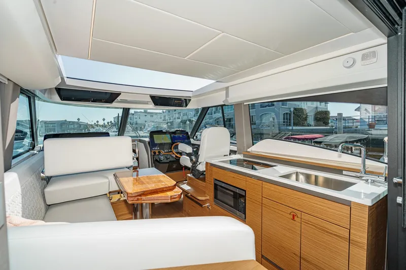Slide: The Image of Interior of 2026 Tiara Yachts 43LE, featuring modern kitchen and seating area. - 34