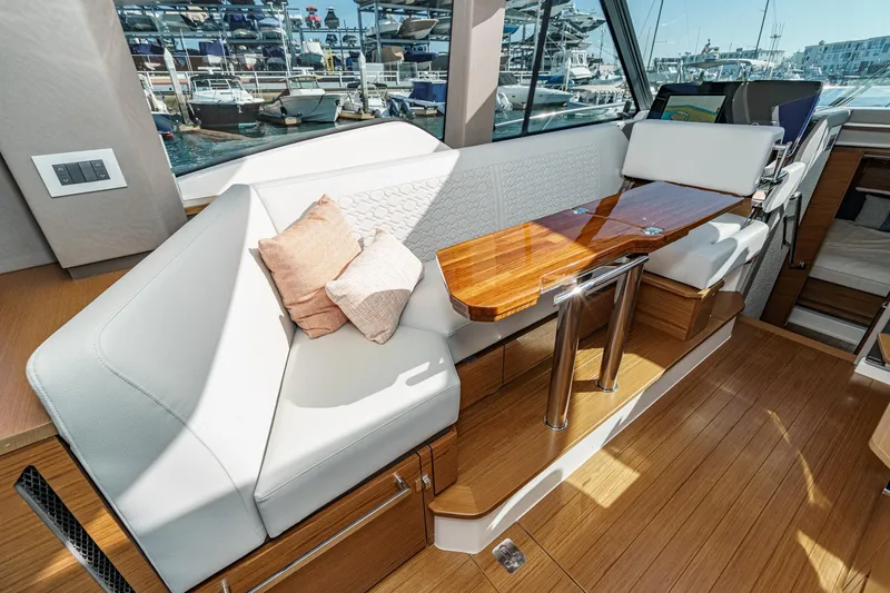 Slide: The Image of Luxurious interior of 2026 Tiara Yachts 43LE with elegant seating and wooden table. - 37