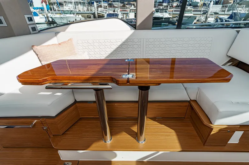 Slide: The Image of Luxurious interior of 2026 Tiara Yachts 43LE with elegant wooden table and seating. - 38
