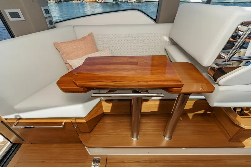 Slide: The Image of Luxurious interior of 2026 Tiara Yachts 43LE with elegant wood table and plush seating. - 39