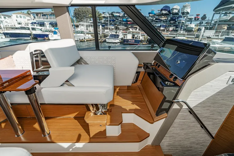 Slide: The Image of Interior of 2026 Tiara Yachts 43LE, featuring helm station and luxurious seating. - 40