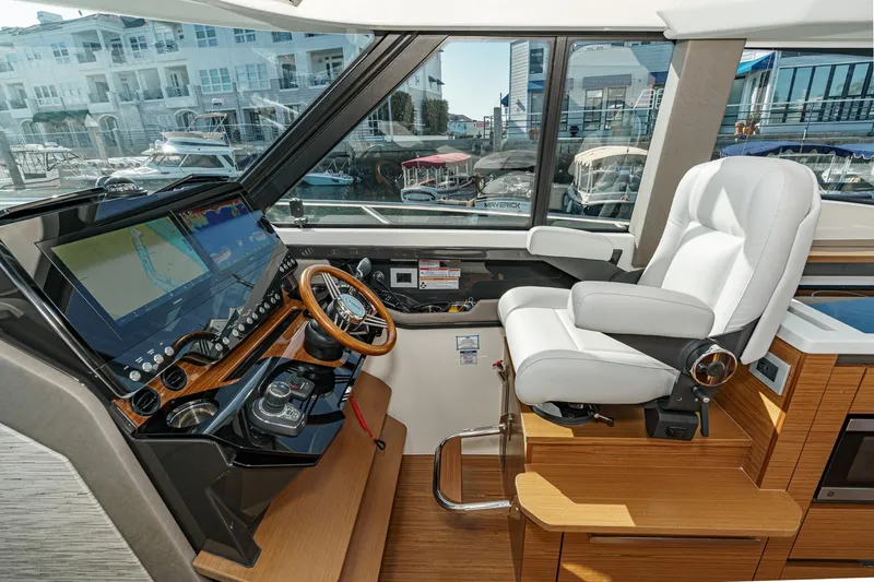 Slide: The Image of Helm of 2026 Tiara Yachts 43LE with modern controls and luxurious seating. - 44