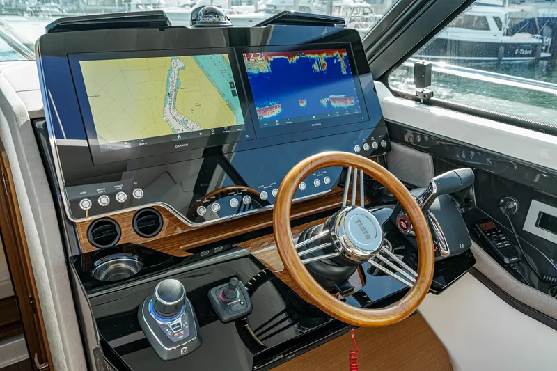 Slide: The Image of Helm of 2026 Tiara Yachts 43LE with advanced navigation displays and controls. - 46