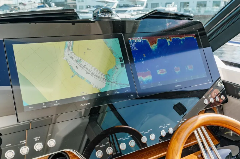 Slide: The Image of Tiara Yachts 43LE 2026 dashboard with Garmin navigation displays and controls. - 47