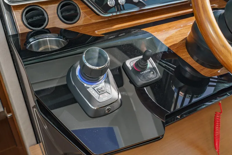 Slide: The Image of Control panel of 2026 Tiara Yachts 43 LE with joystick and steering wheel. - 48