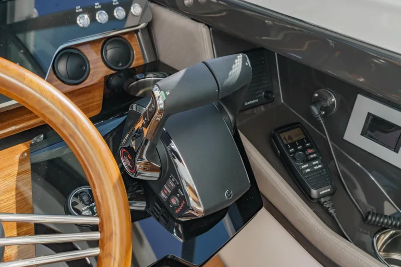 Slide: The Image of 2026 Tiara Yachts 43 LE helm with wooden steering wheel and modern controls. - 49