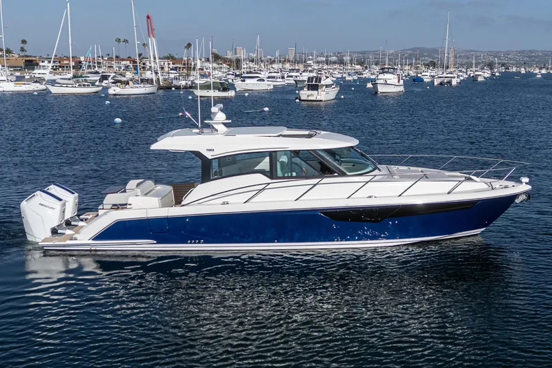 Slide: The Image of 2026 Tiara Yachts 43LE cruising in a marina, surrounded by other boats. - 7