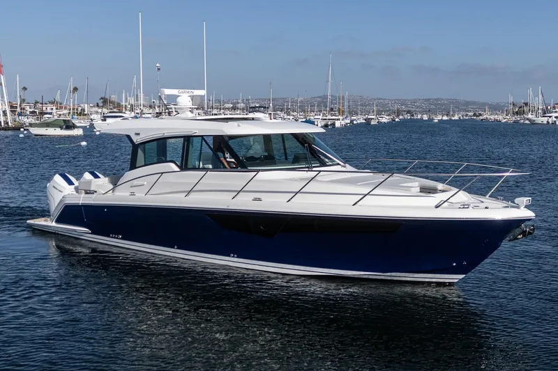 Slide: The Image of 2026 Tiara Yachts 43LE cruising in a marina, showcasing sleek design and modern features. - 8
