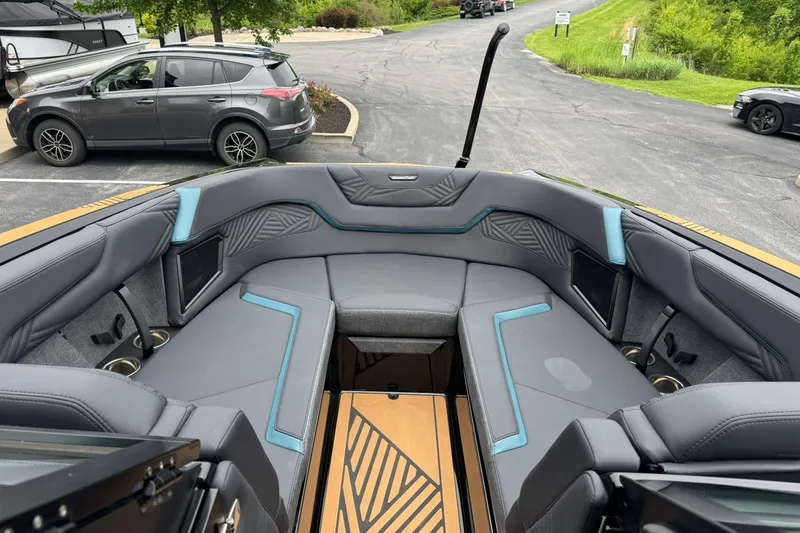 Slide: The Image of 2025 MasterCraft XStar 25 boat interior with sleek gray and blue seating design. - 11