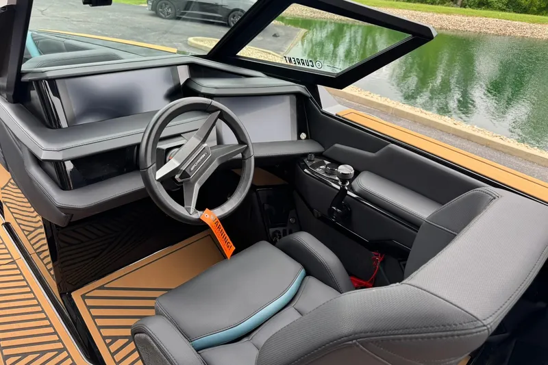 Slide: The Image of Interior of 2025 MasterCraft XStar 25 boat with modern steering and dashboard. - 12