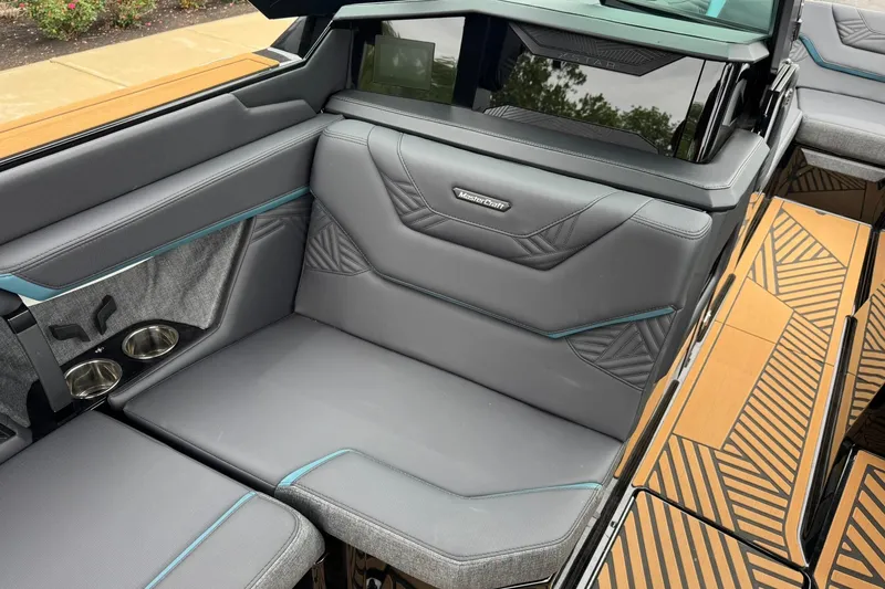 Slide: The Image of Luxurious interior of 2025 MasterCraft XStar 25 boat with gray seating and cup holders. - 13