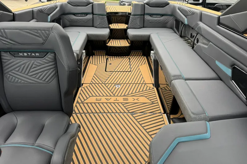 Slide: The Image of 2025 MasterCraft XStar 25 interior with luxurious seating and stylish flooring design. - 14