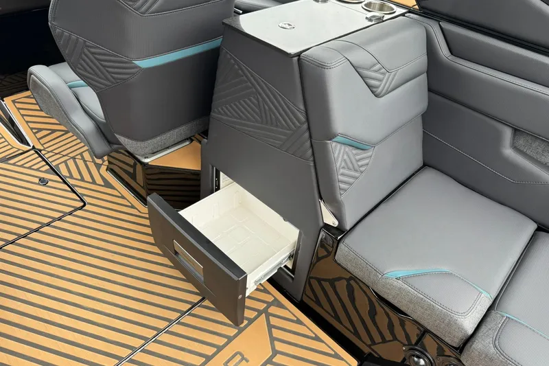 Slide: The Image of 2025 MasterCraft XStar 25 interior with open storage drawer and stylish seating. - 18