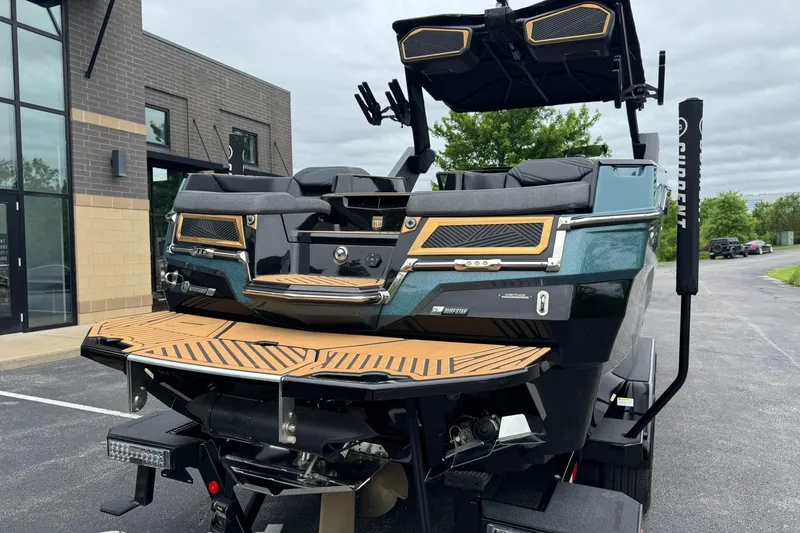 Slide: The Image of 2025 MasterCraft XStar 25 boat with sleek design and modern features, parked outdoors. - 5