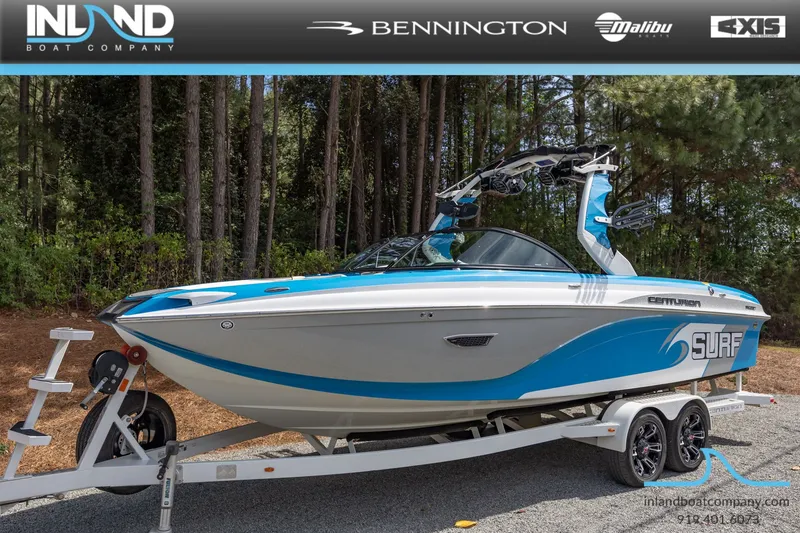 The Image of 2016 Centurion Ri237 surf boat on trailer outdoors. - 1
