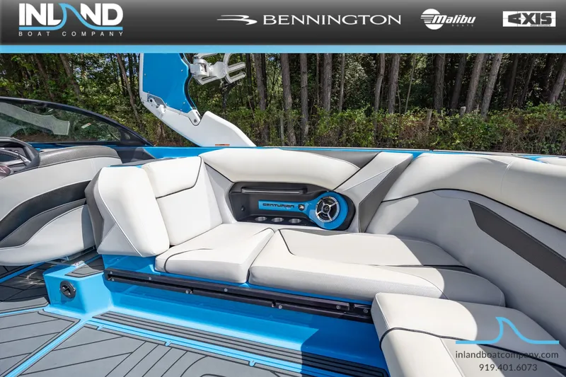 Slide: The Image of Interior of a 2016 Centurion Ri237 boat with blue and white seating. - 14
