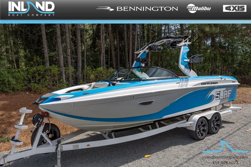 Slide: The Image of 2016 Centurion Ri237 surf boat on trailer in wooded area. - 22