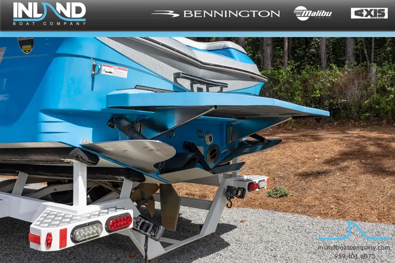 Slide: The Image of Rear view of a blue 2016 Centurion Ri237 boat on a trailer. - 9