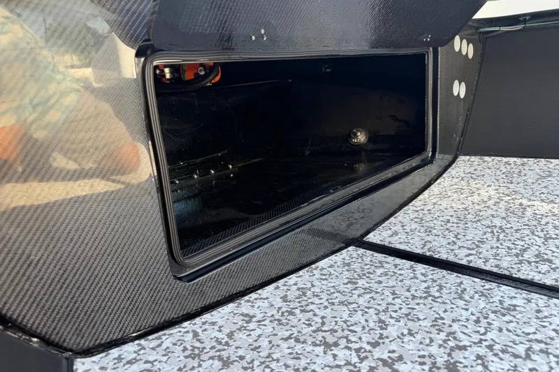 Slide: The Image of Open storage compartment on 2026 Chittum Skiffs 18 Challenger 2.0 Tunnel boat. - 10