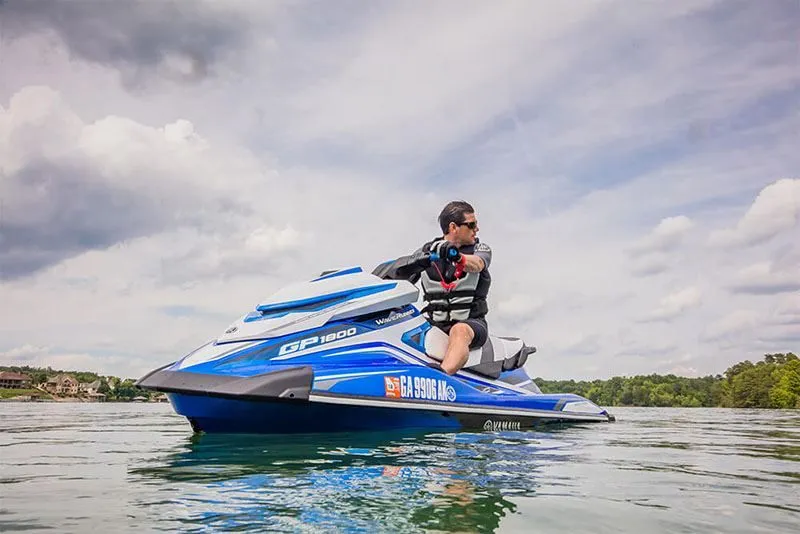 Slide: The Image of Man riding 2017 Yamaha GP 1800 jet ski on a lake. - 12
