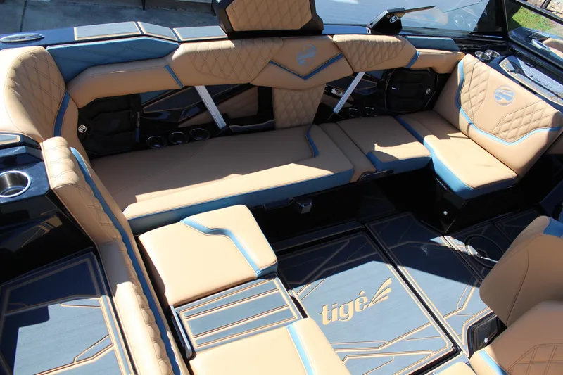 Slide: The Image of Luxurious interior of 2026 Tigé 22RZX boat with tan and blue seating. - 10