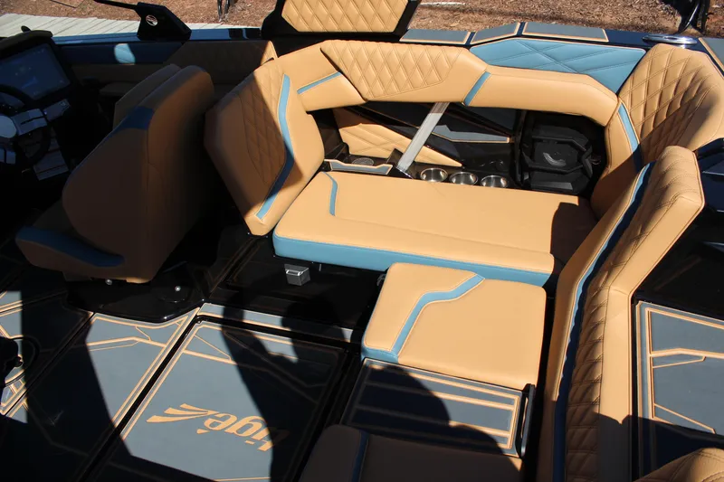 Slide: The Image of 2026 Tigé 22RZX boat interior with tan and blue seating, featuring quilted upholstery. - 11