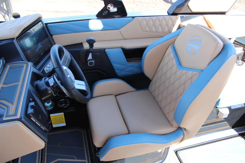 Slide: The Image of 2026 Tigé 22RZX boat interior with tan and blue leather seating and modern dashboard. - 13