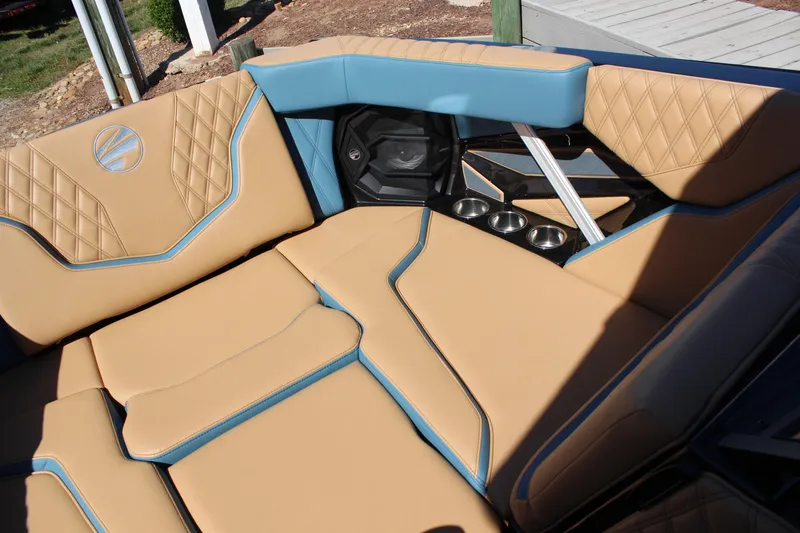Slide: The Image of Luxurious interior of 2026 Tigé 22RZX boat with tan and blue seating. - 15