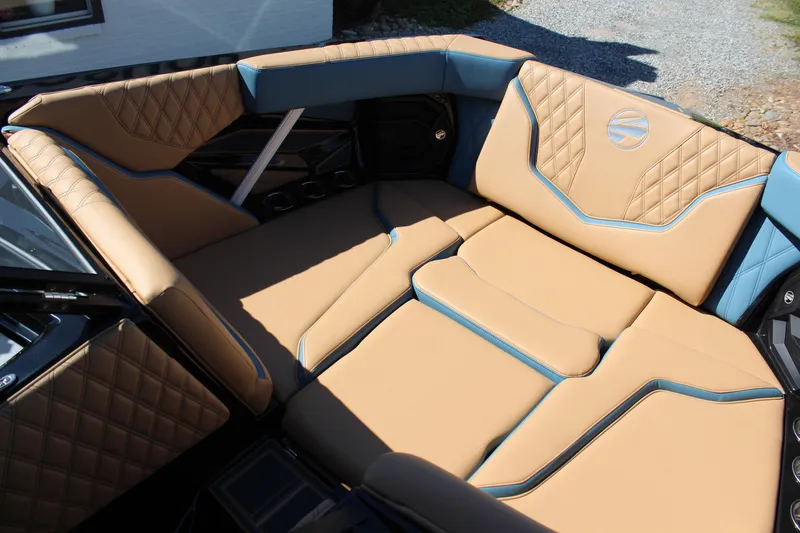 Slide: The Image of Luxurious interior seating of 2026 Tigé 22RZX boat with tan and blue upholstery. - 16