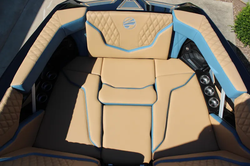 Slide: The Image of Luxurious interior of 2026 Tigé 22RZX boat with tan and blue upholstery. - 17