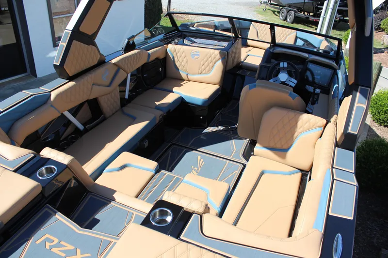 Slide: The Image of Luxurious interior of 2026 Tigé 22RZX boat with tan and blue seating. - 18