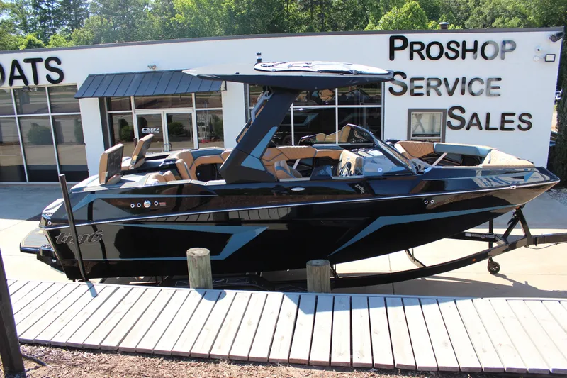 Slide: The Image of 2026 Tigé 22RZX boat displayed at a pro shop service and sales center. - 2