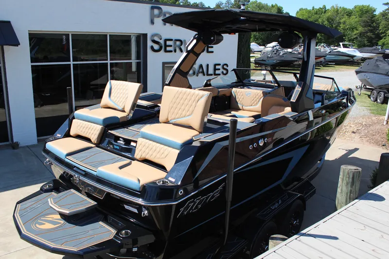 Slide: The Image of 2026 Tigé 22RZX boat with luxurious seating at a dealership. - 6