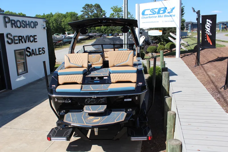 Slide: The Image of 2026 Tigé 22RZX boat at Charlotte Ski Boats dealership, showcasing luxury seating and sleek design. - 7