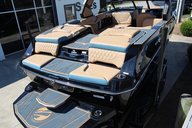 Slide: The Image of 2026 Tigé 22RZX boat with luxurious tan and blue seating, docked outdoors. - 8