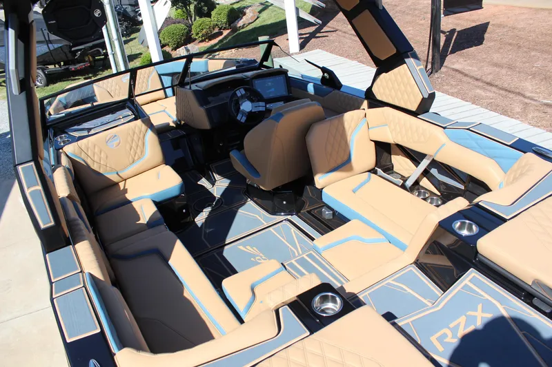 Slide: The Image of Luxurious interior of 2026 Tigé 22RZX boat with tan and blue seating. - 9