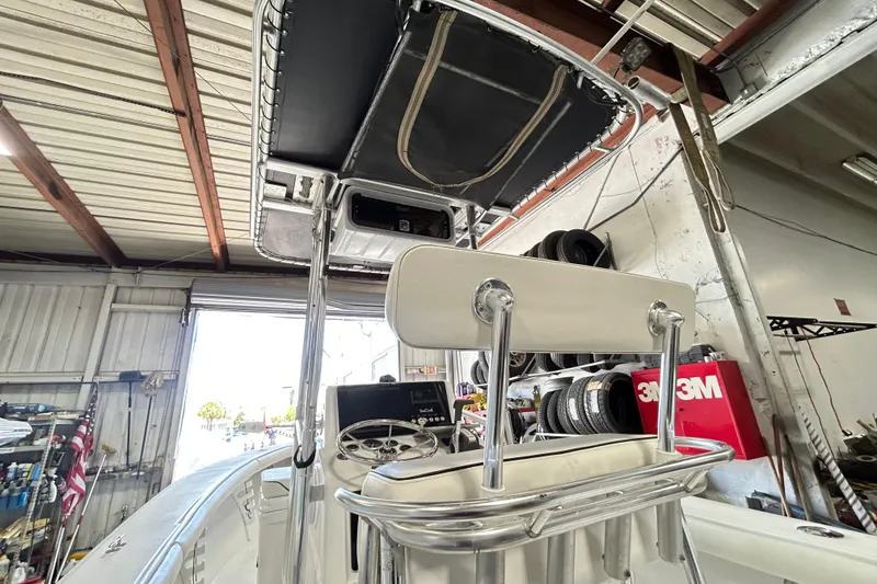 Slide: The Image of 2005 SeaCraft SC 23 Classic boat interior with steering wheel and seating in a garage. - 11
