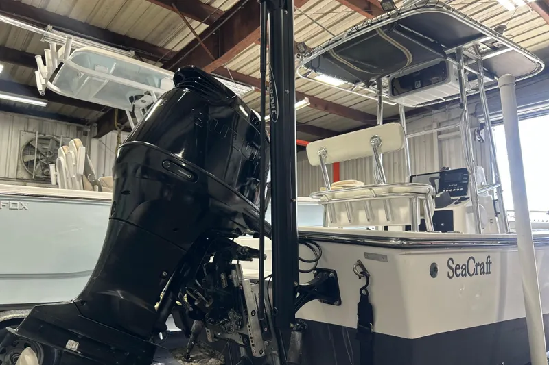 Slide: The Image of 2005 SeaCraft SC 23 Classic boat with outboard motor in a storage facility. - 17