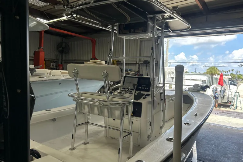 Slide: The Image of 2005 SeaCraft SC 23 Classic boat in a garage, featuring a central console and seating. - 19