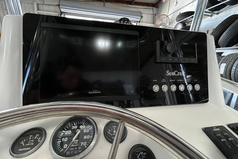 Slide: The Image of Dashboard of a 2005 SeaCraft SC 23 Classic boat with Garmin navigation system. - 3