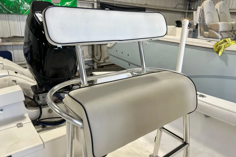 Slide: The Image of 2005 SeaCraft SC 23 Classic boat interior with cushioned seating and motor. - 6