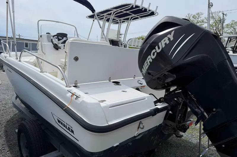 Slide: The Image of 2011 Boston Whaler 180 Dauntless boat with Mercury outboard motor on trailer. - 2
