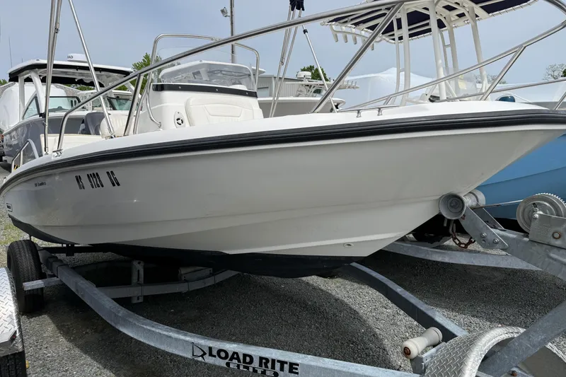 Slide: The Image of 2011 Boston Whaler 180 Dauntless boat on trailer, parked outdoors. - 3