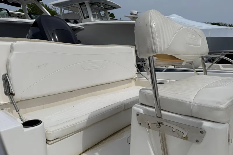 Slide: The Image of 2011 Boston Whaler 180 Dauntless boat interior with white seating and cup holder. - 8