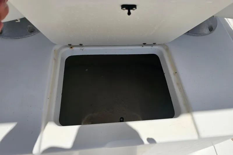Slide: The Image of Open storage compartment on a 1998 Bayliner 2503 Trophy Center Console boat. - 12