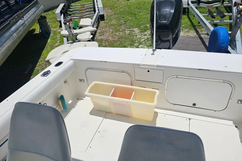 Slide: The Image of 1998 Bayliner 2503 Trophy Center Console boat interior with storage compartments and seating. - 13