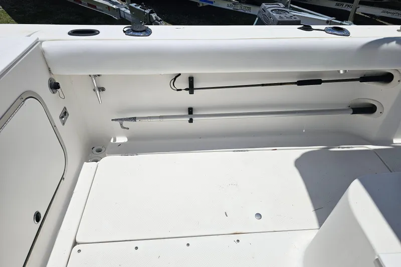 Slide: The Image of 1998 Bayliner 2503 Trophy Center Console interior with fishing rod storage. - 14